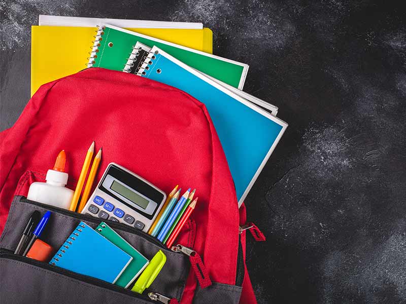 children's school supplies including a backpack and notebooks